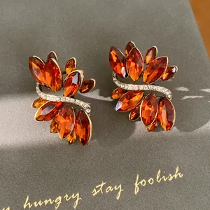 Detail view of vintage style earrings with amber marquise crystals and rhinestones.