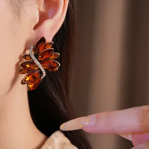 Detailed macro view of vintage amber marquise crystal earrings on a model's ear