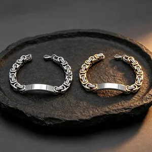 Close-up of silver and gold stainless steel Byzantine chain bracelets for men