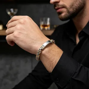 Detailed view of two-tone Byzantine men's stainless steel bracelet on wrist