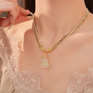 Nahaufnahme eines Modells mit doppellagiger Perlenkette und Jade-Hulu-Anhänger