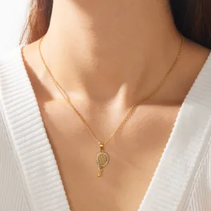 Detailed view of a gold-plated tennis racket pendant necklace with sparkling rhinestones