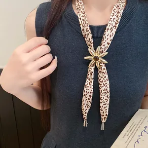 Detailed view of fashion leopard print fabric necklace featuring a gold resin flower pendant