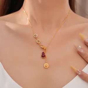 Close-up of elegant 18k gold plated gourd necklace with shell inlay on woman's neck