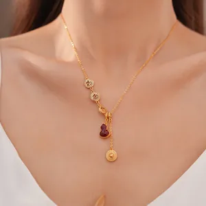 Close-up detail of an 18k gold plated gourd necklace with traditional Fu character charms