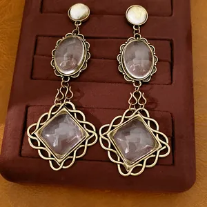 Vintage drop earrings featuring oval and rhombus glass stones with gold lace edge