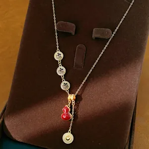 Detailed view of the gold-plated gourd necklace with traditional Fu blessings charms