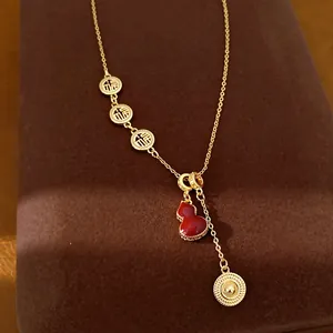 Detailed view of 18k gold-plated gourd necklace with red shell and Fu characters