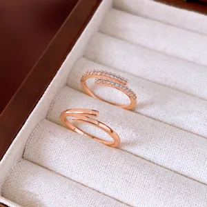Close-up view of elegant rose gold open rings with zircon inlay in a jewelry box