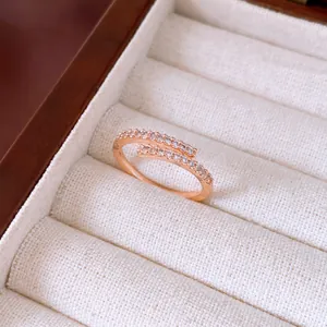 Macro view of a rose gold open ring set with sparkling zircons in a jewelry box