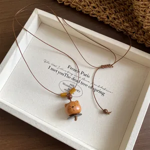 Detail view of the hand-carved wooden bear pendant on an adjustable cord