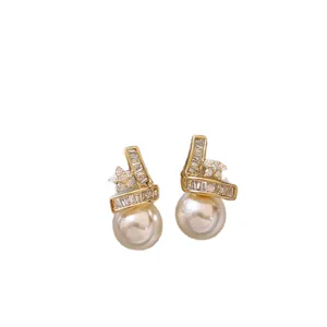 Elegant 14k gold plated star and pearl stud earrings adorned with sparkling zircons