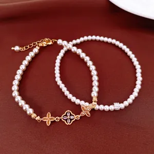 Detail of French style pearl beaded bracelet with gold flower and zircon accents