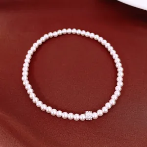 Detailed view of an elegant pearl beaded bracelet with a sparkling zircon bead