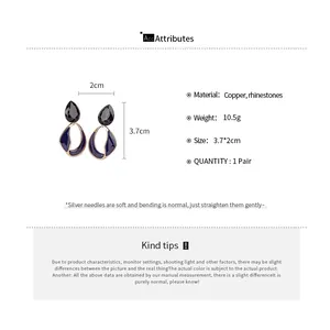 Detail view of 18k gold plated earrings with rhinestones and purple enamel finish