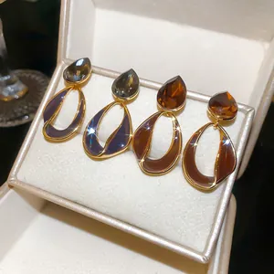 Detailed view of Maillard style gold-plated earrings with drop stones and enamel