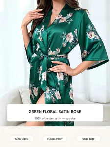 Detailed view of a green floral satin wrap robe with elegant flower print on a model.