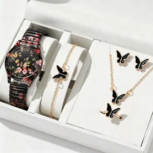 Close-up detail of a floral print quartz watch and black butterfly jewelry set