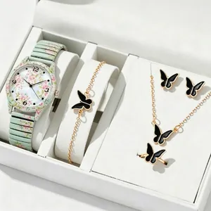 Elegant detail view of floral pattern watch and black butterfly jewelry set in a white box