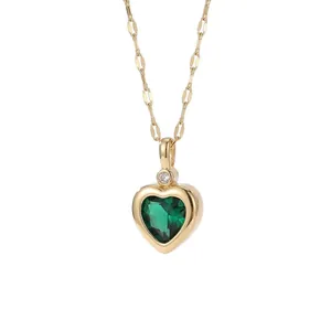 Elegant gold titanium steel necklace with a faceted green heart-shaped crystal pendant.