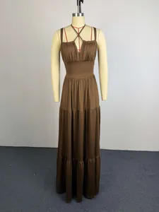 Elegant brown pleated high-waist maxi dress with spaghetti straps on a dress form