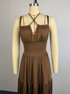 Close-up of a brown halter neck maxi dress featuring a ruched bust and high waist