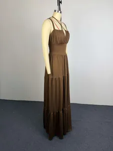 Side view of elegant brown pleated high-waist tiered maxi dress on mannequin