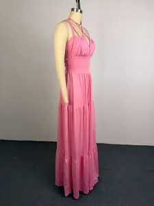 Detailed side view of an elegant pink high-waisted pleated maxi dress on a mannequin