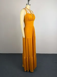 Side view of an elegant mustard yellow pleated high-waist maxi dress on a mannequin.