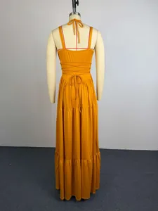 Back view of elegant mustard yellow pleated maxi dress with halter neck tie