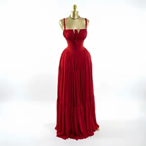 Elegant sleeveless red pleated high-waist maxi gown dress displayed on a gold mannequin