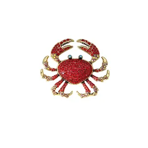 Exquisite vintage gold-tone rhinestone crab brooch with vibrant red and blue crystals