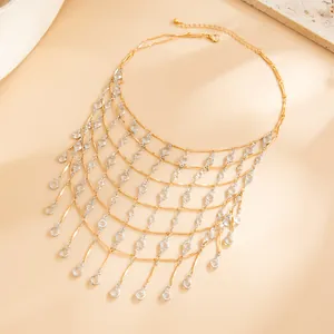 Close-up of gold mesh fringe necklace with crystal teardrop charms
