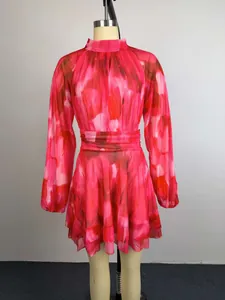 Full view of pink abstract print long sleeve mini dress with pleated waist on mannequin