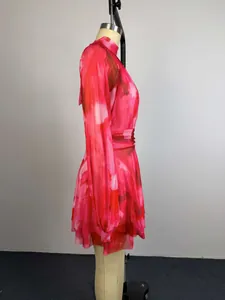 Side view detail of a pink floral printed mini dress featuring a pleated waist and A-line cut