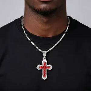 Detailed view of a silver cross pendant with red and white sparkling rhinestones