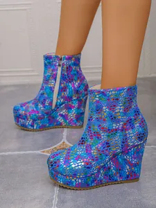 Detail of vibrant blue colorful textured platform wedge ankle boots with side zipper