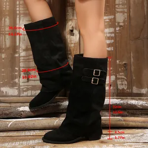 Retro black faux suede slouchy boots featuring chunky heels and decorative side buckles