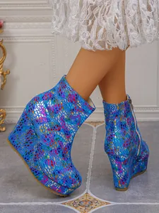 Women's vibrantly patterned blue wedge ankle boots featuring a platform and side zipper
