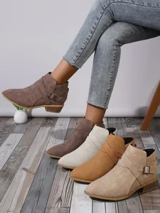 Fashionable pointed toe block heel ankle boots with side buckle straps in neutral tones