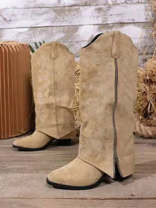 Detailed side view of tan suede embroidered fold-over tall boots with pointed toe
