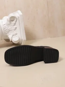 Detail of non-slip rubber sole for women's chunky mid-heel over-the-knee sock boots