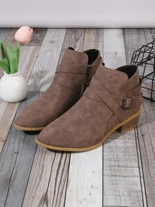 Stylish brown pointed-toe ankle boots for women with side zipper and buckle straps.