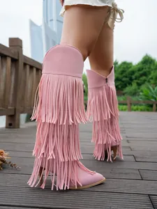 Detail shot of pink suede high heel boots with three layers of long fringe