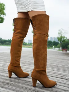Detailed view of brown suede pointed-toe over-the-knee stretch boots with high heels
