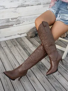 Detailed view of brown embroidered knee-high pointed-toe stiletto boots for women