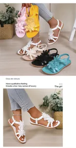 Detailed view of Bohemian flat sandals with elegant flower decorations and cross straps