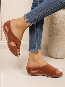 Brown suede wedge slippers with peep-toe and cross-strap design for women
