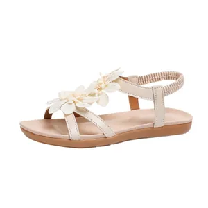 Bohemian flat sandals for women featuring elegant fabric flower accents and cross straps.