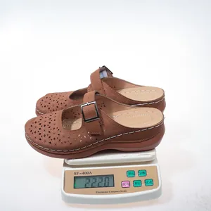 Detailed view of brown floral cutout wedge clogs showing a light product weight of 222 grams